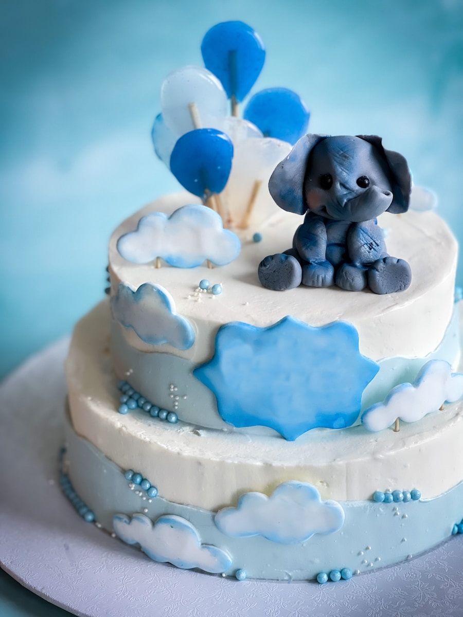 a blue and white cake with an elephant on top