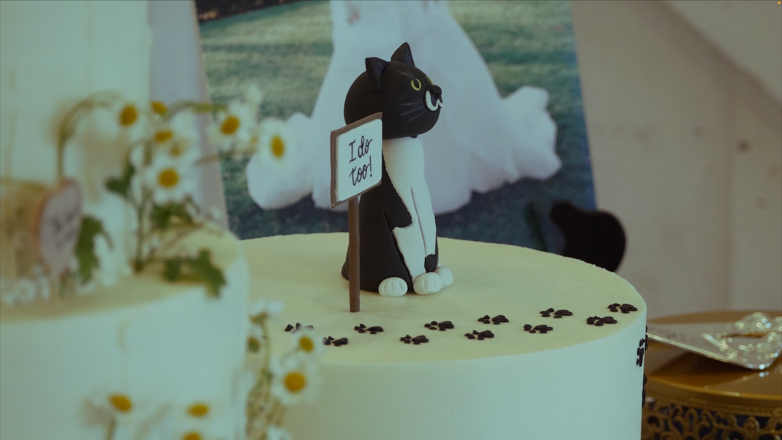 a black and white cat figurine sitting on top of a cake