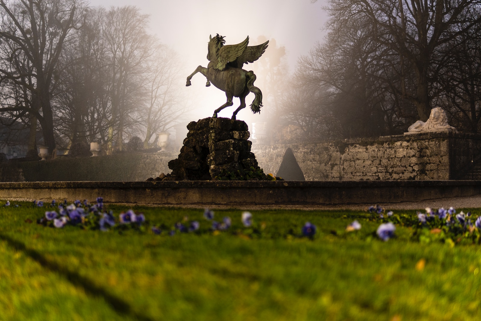 man riding horse statue on green grass field during daytime