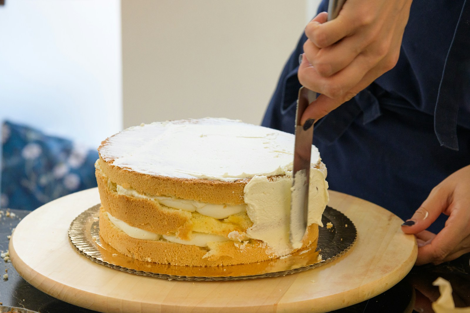 a person cutting a cake with a knife